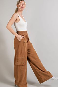 Fit for a day of city explorations, these wide leg mineral washed cargo pants are the epitome of style and functionality. Their distinctive mineral washed finish gives them a worn-in, vintage look that's both trendy and timeless. Equipped with multiple pockets, these pants offer ample storage space while maintaining a comfortable fit, making them a practical choice for outdoor adventures or casual outings. Product Details Material: Self: 100% Cotton. Fit: True to size. Inseam: 31.5” (size Small). Rise: 10.5”Fabric: Stretch cotton. Features: High waisted, wide leg, cargo pockets, elastic waistband, mineral wash. Model: 5’8” / Wearing a size Small. Care: Machine wash cold, gentle cycle. Tumble dry low. Shipping & Returns Free Shipping on U.S. orders +$100. We want you to be 100% satisfied wi