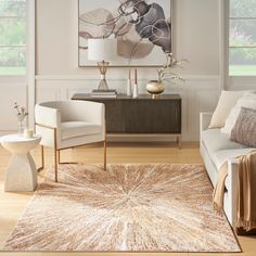 a living room filled with furniture and a large painting on the wall above an area rug