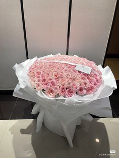 a large bouquet of pink roses is on display