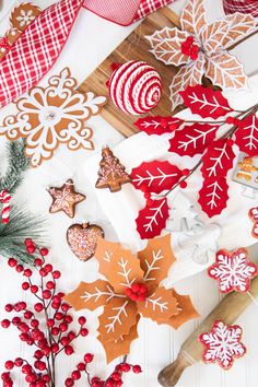 christmas cookies and decorations laid out on a table