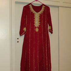 Beautiful Gorgeous Red/Maroon Gold Outfit. Comes With The Maxi Kameez (Shirt), Plazoo Pants (Has Elastic Waist Band) And Dupatta (Shawl). Never Worn Before. All Sales Are Final, No Returns Accepted. Measurements As Follows Which Shows In Inches. Shirt: Shoulder - 14 Bust - 17 Sleeves- 20 Length - 49 1/2 Pants: Length - 37 1/2 Red Straight Kurta Churidar For Formal Occasions, Formal Red Churidar With Straight Kurta, Formal Red Straight Kurta Churidar, Red Georgette Salwar Kameez For Formal Occasions, Formal Red Georgette Salwar Kameez, Formal Red Salwar Kameez With Traditional Drape, Red Sharara With Dabka For Formal Occasions, Red Anarkali Salwar Kameez For Formal Occasions, Formal Red Sharara With Dabka Detail