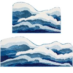 two pieces of blue and white rugs with waves on the top, one in the middle