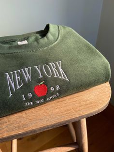 Handmade embroidered New York design onto unisex sweatshirt ✯PRODUCT DETAILS✯ Please note: The photos taken are only indicative every single top is completely handmade therefore all unique! ✯ECO SWEATSHIRT✯  Currently only available in Size Small, Medium and Large  The eco sustainable sweatshirt is made to a very high quality, it's crafted from premium organic and recycled fabrics.  It's 350gsm (so nice and thick) and the inside is a super soft brushed fabric, so will keep you nice and warm! Mat Green New York Hoodie, Cheap Embroidered Sweater For Streetwear, Luxury Urban Sweatshirt With Embroidered Logo, Jumper Embroidery, New York Design, New York Sweatshirt, My Best Friend's Birthday, Lovely Tops, Hoodie Material