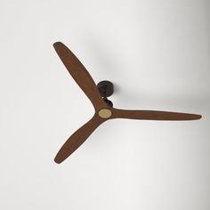 a brown ceiling fan on a white wall