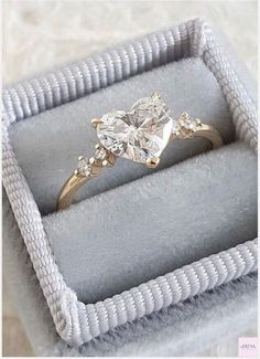 an engagement ring in a box on a table