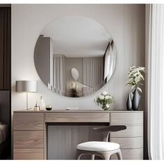 a bedroom with a vanity, mirror and stool