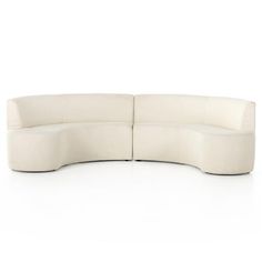 the curved sectional sofa is made from white fabric and has an extended back section, which extends