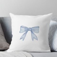 a white pillow with a blue bow on it