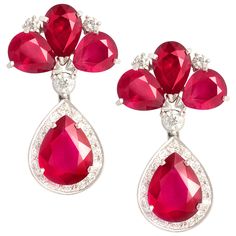 The ruby and diamond drop earrings feature 8 faceted drop shape African rubies of homogeneous brilliance for a total of 21.50 carats. The design is complete with 1.65 carats of top quality round diamonds (G-F/VVS, color, clarity and cut). The earrings are flexible just to the right extent. They were entirely hand made in 18 carat gold by maestro Scalabrì in our own workshop in Italy according to an original design by Ella Gafter. They are signed EG. Victorian Drop Earrings, Ruby And Diamond Earrings, Haute Jewelry, Jewellery Indian, Colored Stones, Spiral Earrings, Bridal Jewellery Indian, Diamond Drop Earrings, Diamond Drops