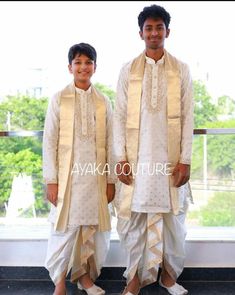 two men dressed in white standing next to each other