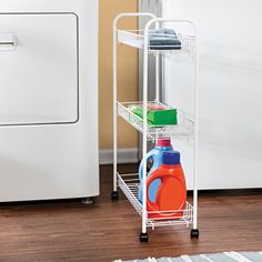 a white dish drying rack next to a washer and dryer