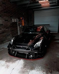 a black sports car parked in a garage