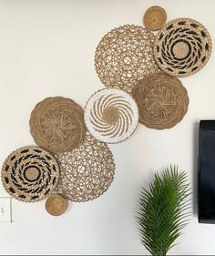 the wall is decorated with woven circles and palm tree in front of a flat screen tv