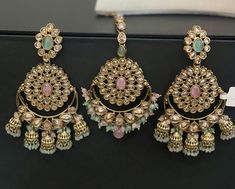 Complete your bridal look with our exquisite Polki Tika Set with Earrings, featuring a stunning mehndi finish adorned with pink and mint green moonstones. This luxurious Pakistani bridal set includes intricate jhumkis and a beautifully crafted tika, perfect for Indian weddings and special occasions. The combination of traditional design and modern elegance ensures you stand out on your big day. Elevate your jewelry collection with this timeless and sophisticated set. Shop now to add a touch of opulence and cultural charm to your ensemble.  Our products are meticulously handcrafted, ensuring each piece is unique. Due to the manual craftsmanship, you may notice slight irregularities, which are natural and do not compromise the quality of the jewelry. Modern Indian Jewelry, Pink And Mint, Indian Weddings, Bridal Look, Pakistani Bridal, Bridal Set, Moon Stone, Bridal Sets, Modern Elegance