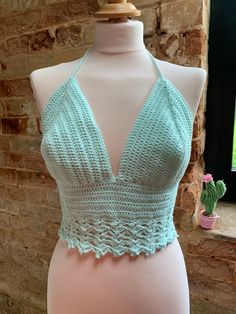 a mannequin wearing a crocheted halter top