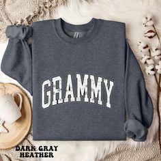 Surprise your Grammy with this cozy sweatshirt! Perfect for cozy nights in or casual outings, this gift will make her feel cherished and loved every time she puts it on! PLEASE CHECK THE SIZE CHART IMAGE TO HELP YOU CHOOSE THE BEST FIT! :) WE DO NOT ACCEPT EXCHANGES, RETURNS OR CANCELLATIONS We add our size chart as a reference, so please make sure that you are selecting carefully. Once an order is received it goes into production and we are unable to cancel orders. ♥♥Of course if there is an is Cozy Winter Sweatshirt With Text Print, Cozy Sweatshirt With Text Print, Cozy Sweatshirt With Text Print For Loungewear, Cozy Text Print Sweatshirt For Loungewear, Cozy Gray Tops With Letter Print, Cozy Gray Letter Print Top, Cozy Gray Top With Letter Print, Comfy Fleece Sweatshirt With Letter Print, Cozy French Terry Top With Letter Print