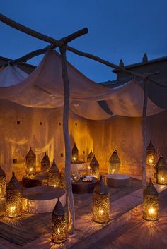 an outdoor seating area with candles lit up