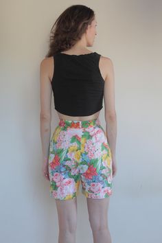 Cool Kenzo Paris multi colored floral printed high waisted shorts. Perfect 80's high fashion street wear. Fabric is a medium weight cotton. Shorts have pleats in the front, darts at the waist in back. Side front pockets. Cuff at the shorts hem. Front plastic zipper with button at the waist. Label Kenzo Paris, Size 38, 100% cotton, wash cold, hang dry. Very good vintage condition with no fabric or sewing flaws. Measurements Waist 62cm/ 24.5inches Hips 102cm/ 40inches Waist to hem 44cm/ 17inches M Retro Summer Floral Print Bottoms, Retro Floral Print Summer Bottoms, Fitted Floral Print Shorts, Fitted Casual Shorts With Floral Print, Summer Floral Print High-waisted Shorts, Fitted Floral Print Shorts For Summer, Retro Floral Print Short Bottoms, Fitted Cotton Shorts With Floral Print, Fitted Summer Bottoms With Floral Print