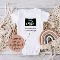 "This personalized baby outfit is a sweet way to announce your miracle on the way. Personalize it with your own ultrasound printed on, a phrase of your choice, and the color of the \"tape\" that holds the ultrasound up (blue, pink, or yellow). HOW TO ORDER: * Select the color and size you want and add the item to your cart * Enter your personalization: What phrase you want and what color \"tape\" holding up your ultrasound image - blue, pink, or yellow * After purchasing, send me a message with White Onesie With Letter Print For Gender Reveal, Personalized Fitted Onesie For Gender Reveal, Short Sleeve Onesie With Custom Print For Gender Reveal, Personalized White Onesie For Father's Day, Custom Print Short Sleeve Onesie For Gender Reveal, Customizable White Onesie For Gender Reveal, Personalized White Onesie As A Gift, Personalized White Onesie As Gift, Gift Custom Print Short Sleeve Onesie