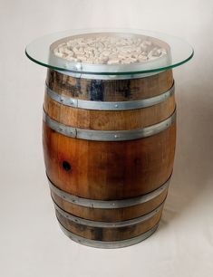 a wooden barrel table with glass top