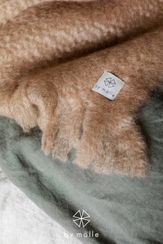 a close up of a blanket with a tag on it