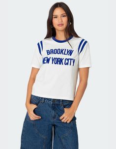 This Trendy T-Shirt Will Have You Reppin New York Like You're A Local. With It's Perfectly Cropped Fit And Cute Contrast Detailing, It's A Great Option For A Casual Comfy Fit. T-Shirt. Contrast Neckline. Stretchy Shoulder Stripe Detailing. Velvet Text. 95% Cotton, 5% Spandex. Model Wears Size S. Model Height Is 5'7. Item Care: Machine Wash At Maximum 30ºc, Do Not Bleach, Tumble Dry Low, Iron At A Maximum Of 110ºc, Do Not Dry Clean. | Edikted New Yorker Tee Visionary Fashion, Swimwear Dress, Top Graphic Tees, Pant Shirt, Trendy Tshirts, Cut Shirts, Skirted Swimwear, Short Rompers, Hoodie Dress