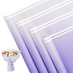 a bouquet of flowers sitting in front of some purple and white wall paper with stripes on it