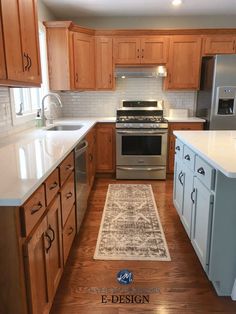 a kitchen with wooden cabinets and white counter tops, an area rug on the floor