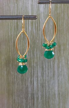 Bold and eye catching. These vibrant green onyx earrings have just enough cool emerald shades in them to compliment every type of style. Wear with your favorite little black dress or a tank top and jeans. The earrings are made with green onyx briolettes accented with a cluster of green Tank Top And Jeans, Top And Jeans, White Plains, Onyx Earrings, May Birthstone, Earrings Statement, Green Onyx, Vibrant Green, Wire Work