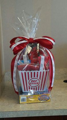 a red and white striped basket filled with food