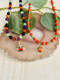 "The adorable beaded pumpkin charm necklace is hand made in the USA. Made with a beaded chain and a lobster claw clasp. This necklace is the perfect accessory for any kids wardrobe.   This necklace is a great kids gift.  The necklace is a length of  Pumpkin 16\" - 18\" Pumpkin Hat 14\" - 16\""