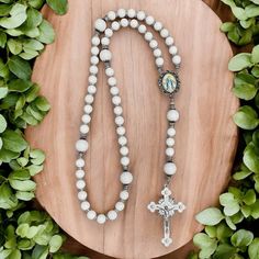 This special Rosary represents Our Lady of Grace, who is the one who intercedes for us with God to obtain His grace. It features pure white tridacna for both the Hail Mary beads and the Our Father Beads, which are offset by silver-plated nuggets along the Rosary. A vintage-style image of Our Lady of Grace is at the center of the Rosary and the crucifix is crafted with white enamel and accented with rhinestones. White Jewelry With 8mm Beads For Gift, White Jewelry With 8mm Beads As Gift, White Pearl Jewelry With Silver Beads, White 8mm Beads Jewelry As Gift, White Spiritual Necklace With Polished Beads, Spiritual White Necklaces With Polished Beads, White Gemstone Beads Jewelry For Wedding, Adjustable White Rosary With 108 Beads, White Pearl Rosary As A Gift