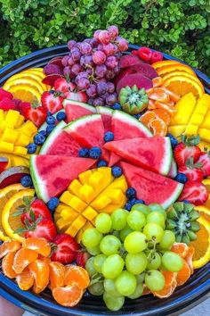 a platter filled with lots of different types of fruit