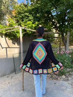 in stock! Granny square black boho style patchwork cardigan is combined with inspiration from the rainbow. :) The yarn used in the cardigan is cotton. It will be a unique gift to have a wonderful product for your loved ones for their birthdays and special occasions! Be the sparkle of your festivals and parties! Cardigan Sizes Width 105 cm / 41.3 inch Height 70 cm / 27.5 inches Model Size: 178 cm / 5 Feet 10.79 Inches / 63 kg - 138 lb. washing information It can be washed in the hand wash program Handmade Black Bohemian Outerwear, Bohemian Black Patchwork Outerwear, Black Bohemian Patchwork Outerwear, Bohemian Black Outerwear With Patchwork, Black Bohemian Handmade Outerwear, Granny Square Long Sleeve Festival Cardigan, Granny Square Long Sleeve Cardigan For Festivals, Bohemian Black Cardigan With Granny Square, Black Bohemian Cardigan With Granny Square Details