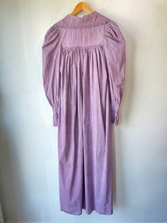 Vintage Purple Victorian Nightgown. Lace-trimmed nightgown with bow details and puffy sleeves that make you feel like you're in a haunted 1920s mansion. The collar has black details that bring out the lacey designs. In good vintage condition with a few missing buttons (sold as is). Fits like a S/M. Feels like cotton/linen. Approx. Measurements: Underarm to underarm: 18" Length: 55" Puff Sleeve Vintage Dress For Daywear, Regency Style Long Sleeve Vintage Dress For Daywear, Elegant Cotton Dress For Night, Elegant Night Cotton Dresses, Vintage Dresses For Spring Night, Vintage Night Dresses For Spring, Long Sleeve Lace Trim Dress For Night, Long Sleeve Dresses With Lace Trim For Night, Vintage Prairie Dress With Gathered Sleeves