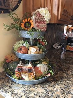 three tiered trays filled with fall decorations