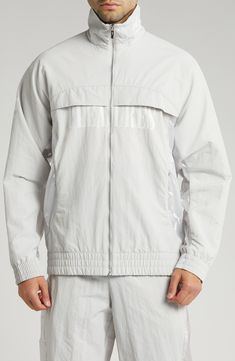 This relaxed-fit track jacket is part of a collab with PLEASURES and is inspired by a clash of racing and punk-inspired streetwear. Bold tonal branding for both labels subtly reflects against the sleek nylon on the outerwear, while underarm ventilation keeps it breathable throughout the day. 28" length (size Medium) Front zip closure Stand collar Elastic cuffs and hem Side zip pockets Underarm ventilation Water-repellent 100% recycled nylon Machine wash, tumble dry Imported PUMA has received the Punk Inspiration, Puma X, Track Jacket, Track Jackets, Stand Collar, Water Repellent, Side Zip, Zip Pockets, The Day