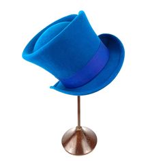 Add a touch of magical charm to your outfit with our Mad Hatter Felt Top Hat! Inspired by the beloved characters from Alice in Wonderland. This hat is crafted from high-quality felt that's both durable and soft to the touch. The shape and the color felt on the hat will instantly transport you to the magical world of Wonderland.  Perfect for costume parties, themed events, or even as a statement accessory, this Mad Hatter Felt Top Hat is sure to turn heads and make you the center of attention wherever you go. So embrace your inner Mad Hatter and stand out from the crowd with this enchanting hat! Measurements in centimeters are 31 x 25. Crown height 15. Brim length 5.5. These measurements may have some slight variation depending on the size of the hat. All our felt hats have a 100% natural r Novelty Costume Hat With Curved Brim, Adjustable Costume Hats For Themed Events, Adjustable Wide Brim Costume Hats For Themed Events, Adjustable Brimmed Felt Costume Hat, Adjustable Brimmed Felt Hat For Costume, Adjustable Flat Brim Costume Hat, Fitted Brimmed Hat For Themed Events, Themed Costume Hats With Adjustable Curved Brim, Themed Mini Hat With Curved Brim For Costumes