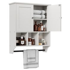 a bathroom cabinet with towels and other items