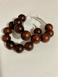 Silver tone hoops with dark brown wood beads. Buffalo Ny, Beaded Hoop Earrings, Beaded Hoops, Jewelry Earrings Hoops, Brown Wood, Wood Beads, Dark Brown, Buffalo, Silver Tone