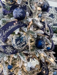 a christmas tree decorated with blue and silver ornaments