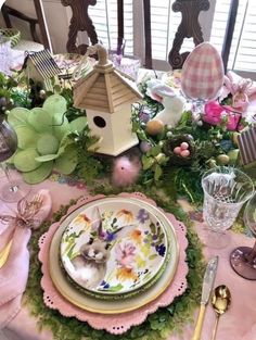 a table set with plates, napkins and place settings for an easter bunny party