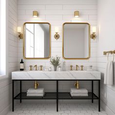 a bathroom with two sinks and mirrors on the wall