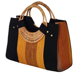 If you love elegant and classy handbags and love making a statement then this bag is for you! With sturdy and gorgeous cane handles and a stunning combination of colors from the Fugu fabric, the bag is practically royalty. The Fugu or Smock fabric is a luxury native fabric worn mostly by the royals of the Northern Tribes of Ghana. This bag also comes with an inner pocket with a zip fastening and provides lots of space, it's even big enough for a small laptop! As if that was not awesome enough, w Elegant Brown Beach Bag, Elegant Brown Handheld Beach Bag, Chic Multicolor Handwoven Bag, Chic Handwoven Multicolor Bag, Black Shoulder Bag With Bamboo Handle For Travel, Black Travel Shoulder Bag With Bamboo Handle, Top Handle Beach Bag With Bamboo Handle For Shopping, Daily Use Brown Beach Bag With Round Handle, Rectangular Market Bags With Detachable Handle