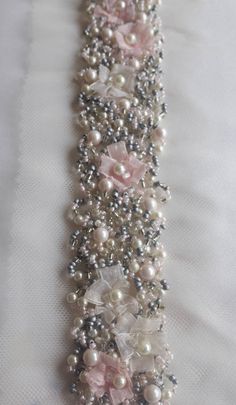 a bracelet with pearls and flowers on it