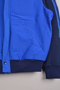 "Vintage Adidas windbreaker in a blue color way. This Adidas track jacket is in great condition only a button(see image) is missing. Size: 52 Material: 70% Polyamide 30% Cotton Made in Finland Measurement: - Chest(armpit to armpit: 55cm(21.5\") - Length from the backside(Center bottom of the collar to center bottom of the garment): 62cm(24.5\") - Sleeve(Shoulder seam to end of arm cuff): 61cm(24\") NOTE: Because of the age, clothing can shrink or the sizing from that time wasn't the same as the Sporty Blue Varsity Jacket For Streetwear, Blue Sporty Outerwear With Fleece Lining, Blue Hooded Outerwear With Three Stripes, Blue Sporty Windbreaker With Fleece Lining, Blue Adidas Logo Outerwear For Winter, Blue Varsity Windbreaker With Long Sleeves, Blue Adidas Logo Winter Outerwear, Blue Varsity Long Sleeve Windbreaker, Blue Athleisure Track Jacket With Ribbed Cuffs