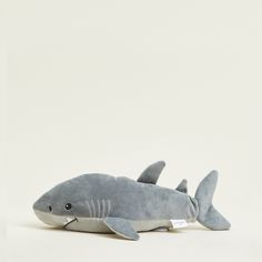 a stuffed shark is laying down on the floor