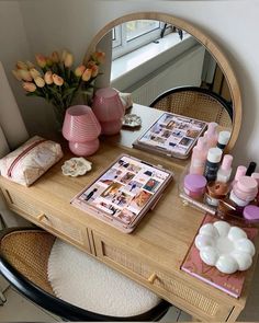 a vanity with cosmetics and flowers on it