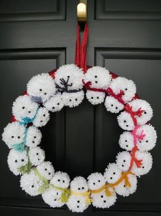 a crocheted wreath is hanging on the front door