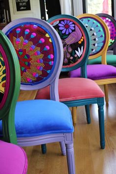 colorful chairs are lined up in a row